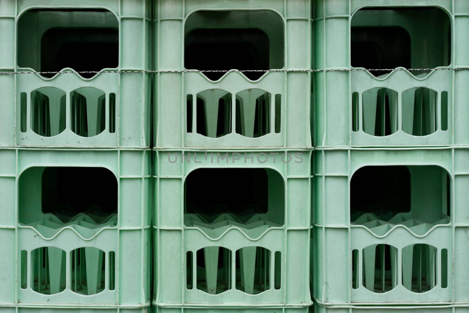 Stacked empty bottle crates background texture pattern.