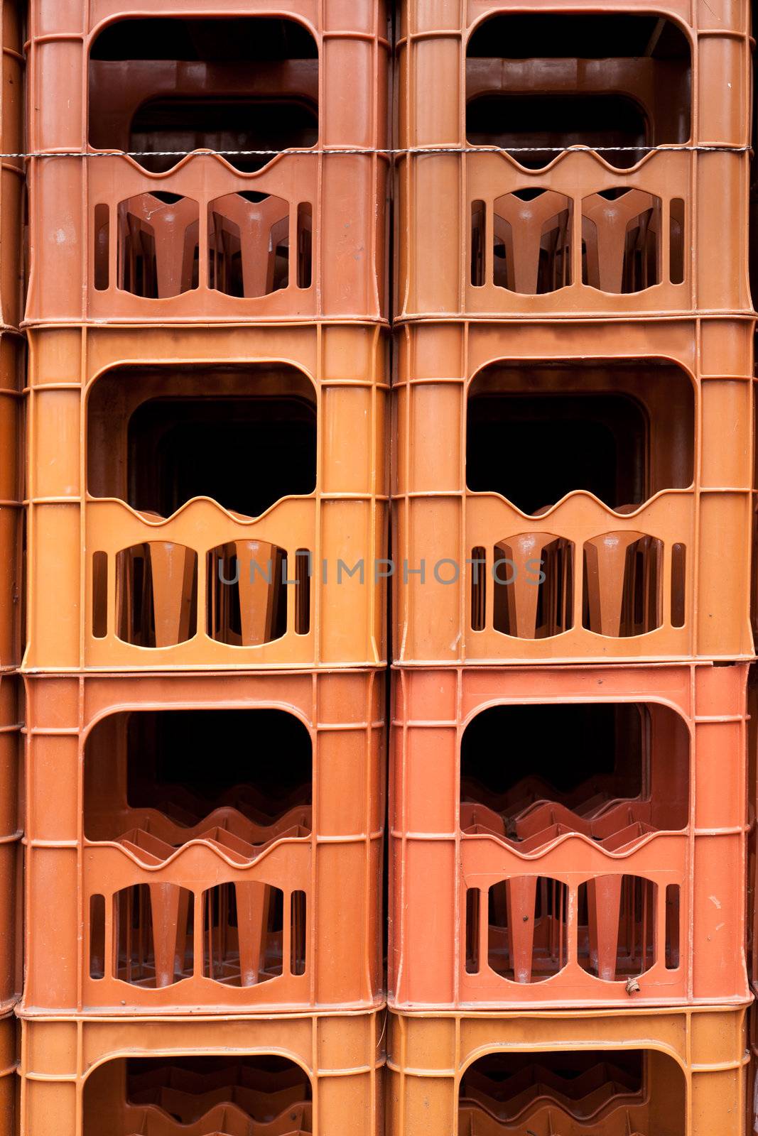 Stacked empty bottle crates background texture pattern.