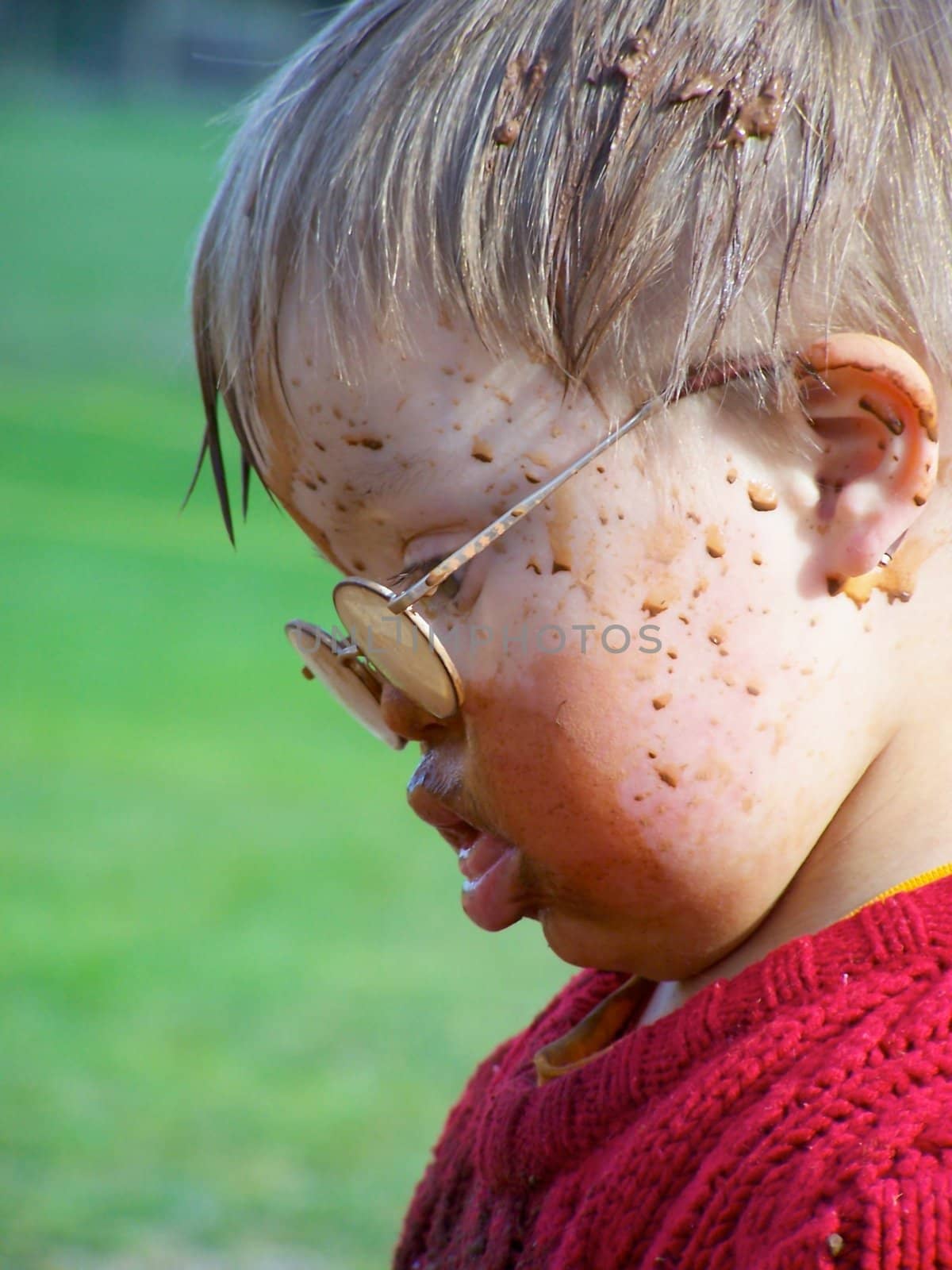 Downs Syndrome boy with mud on his face
