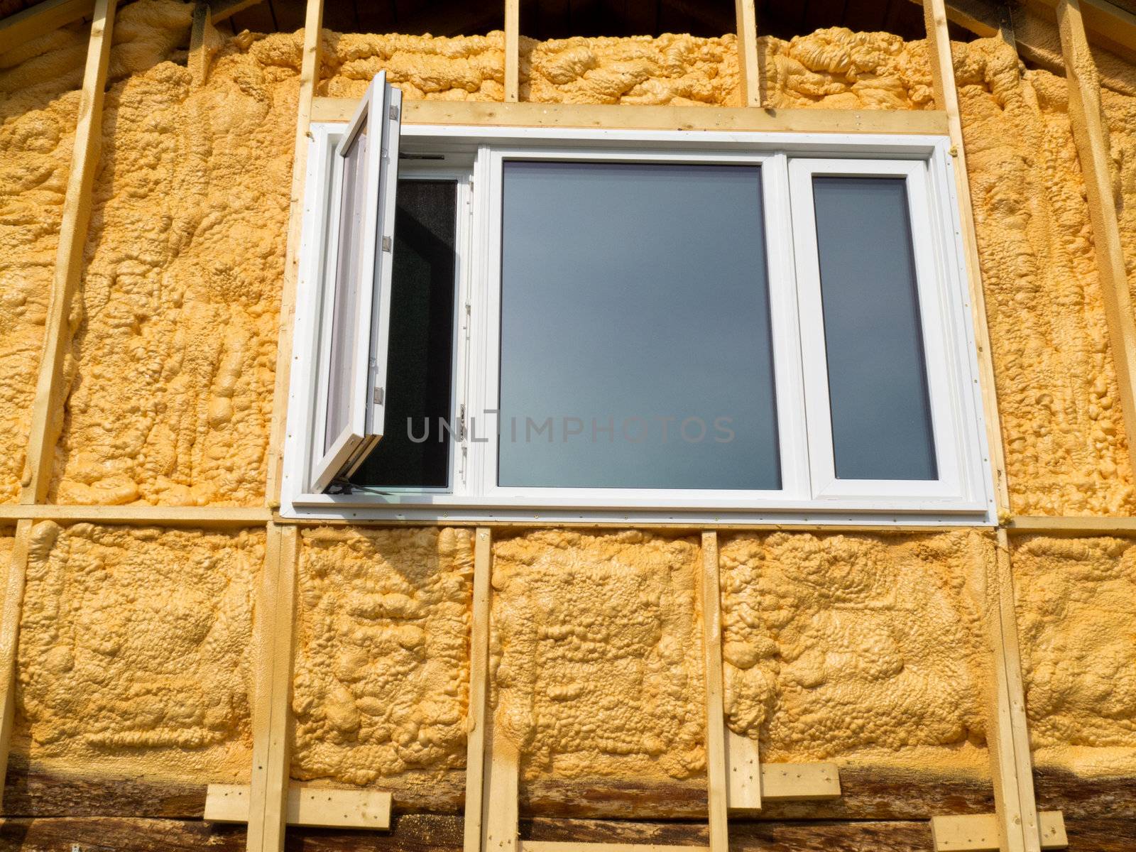 Renovation of old house: wall is sprayed with liquid insulating foam before the siding goes on.