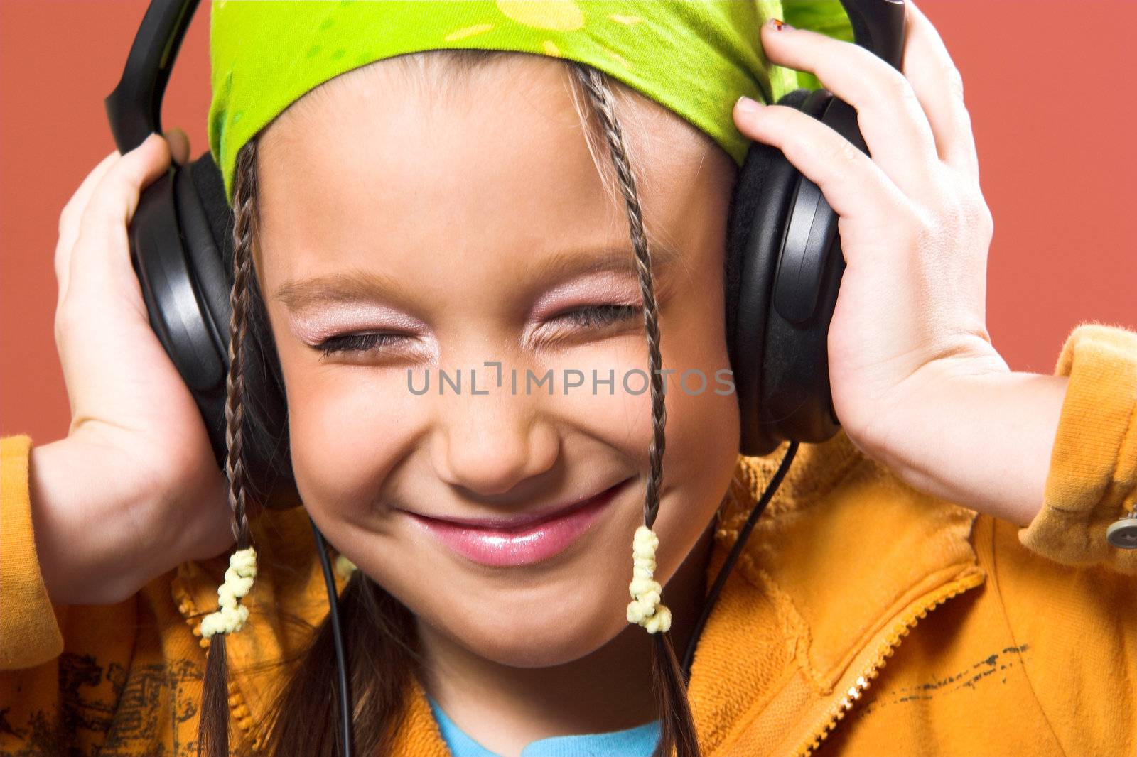 little pretty child listening music in headphones