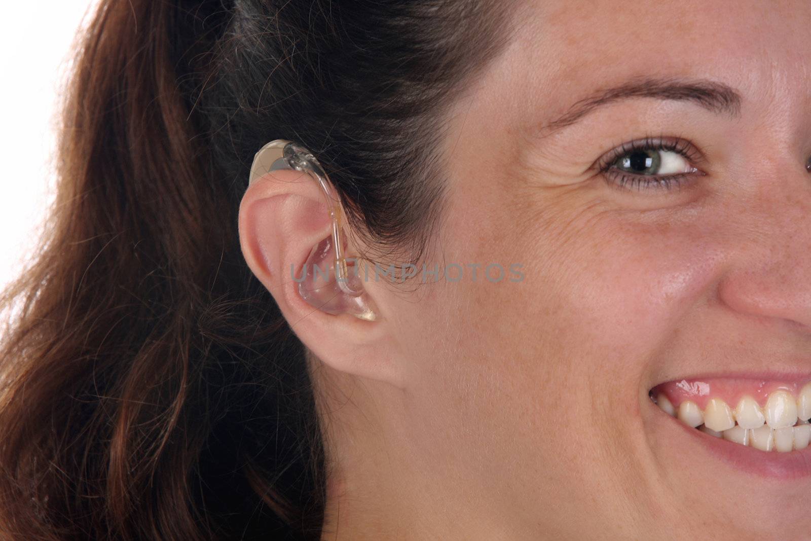 Beautiful young woman with hearing aid, closeup shot