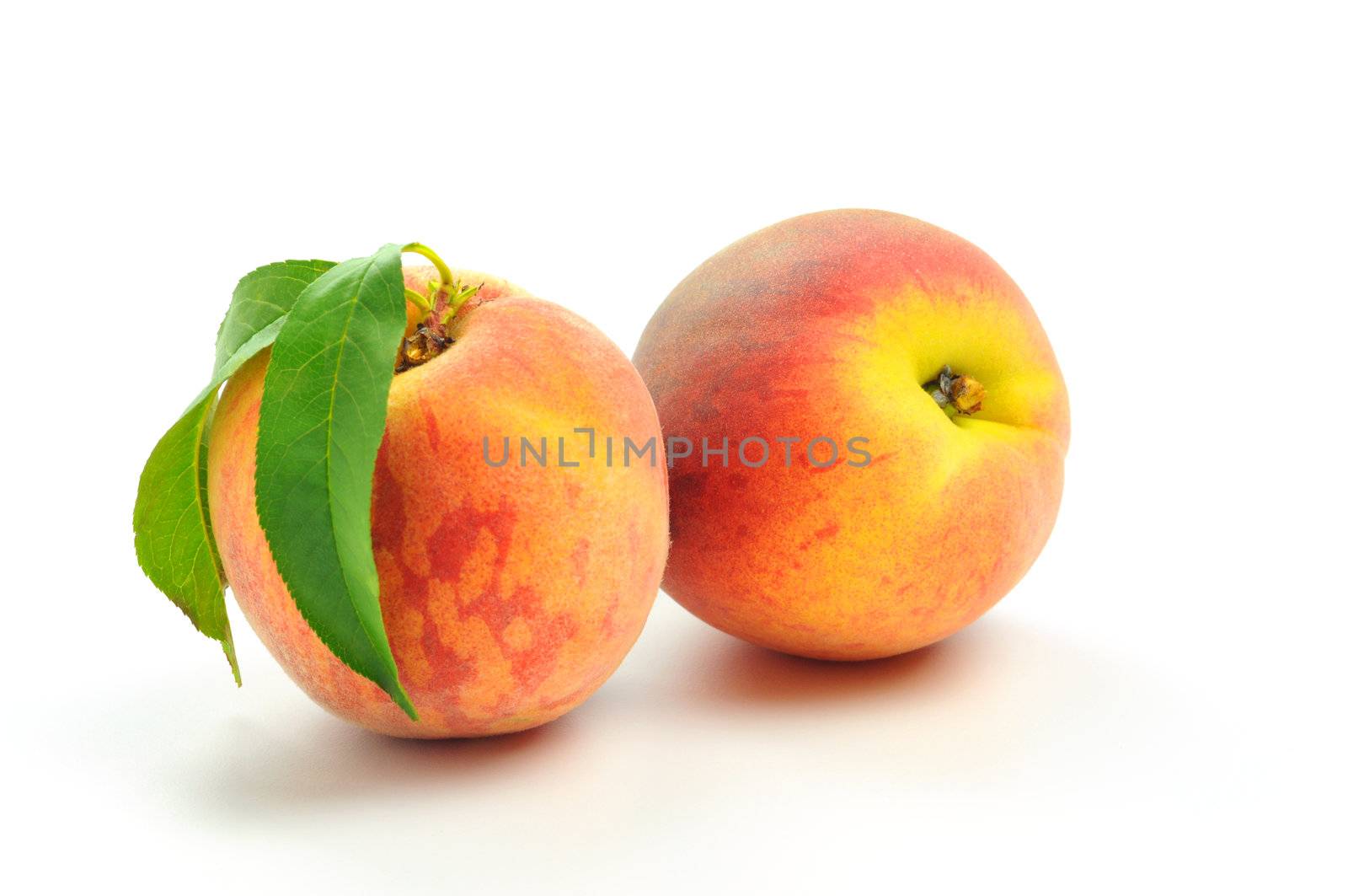 Delicious ripe peaches on a white background.