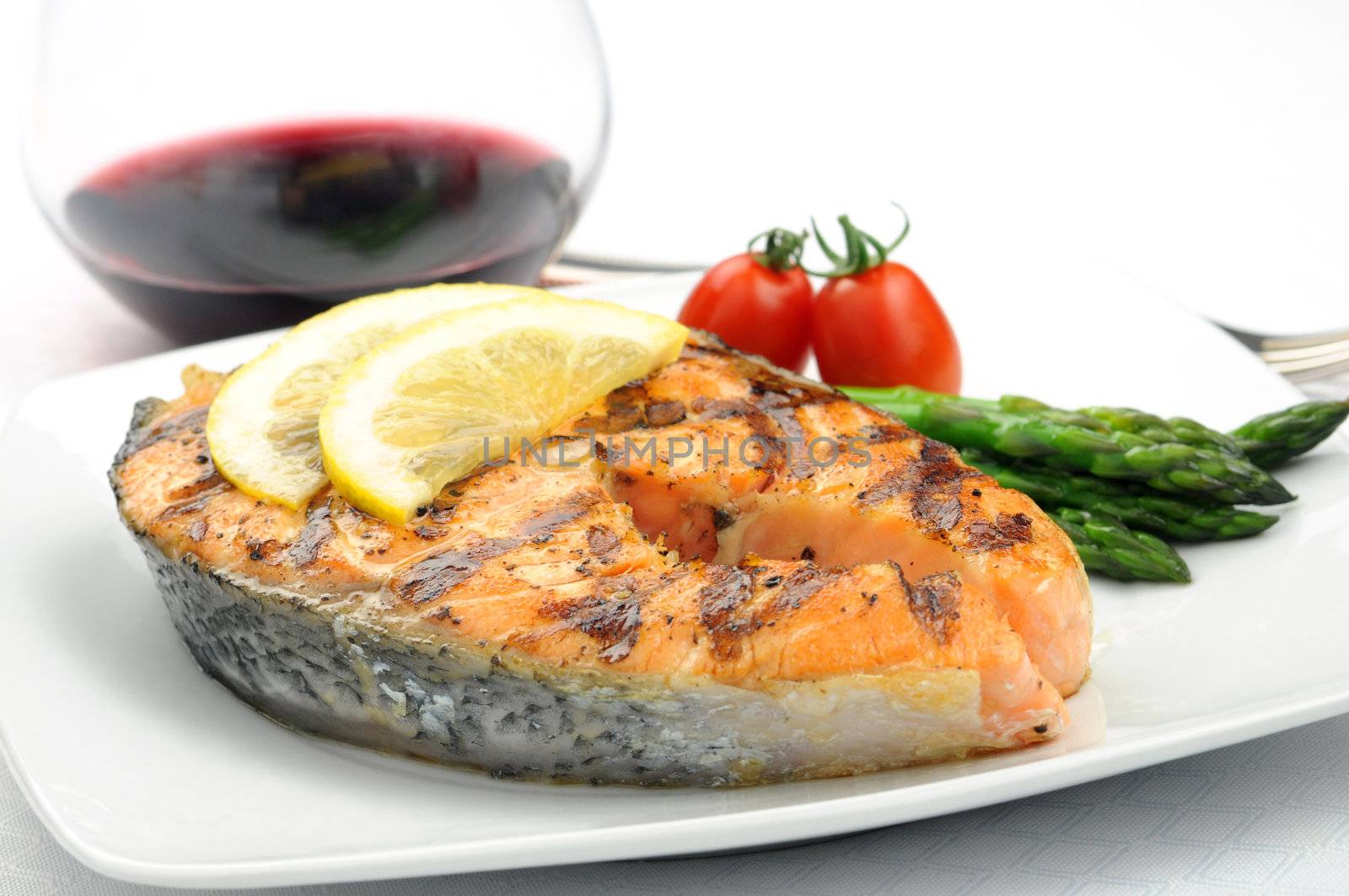 Fresh grilled salmon steak and colorful vegetables.