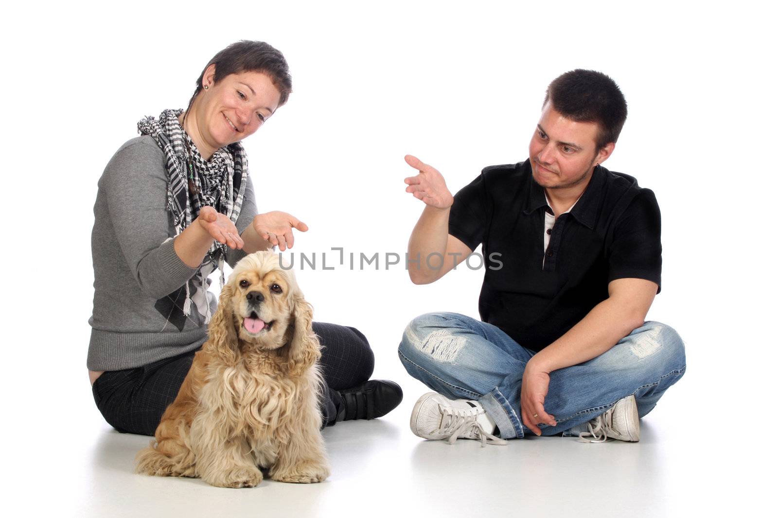 Girl, guy and american cocker spaniel over a white background