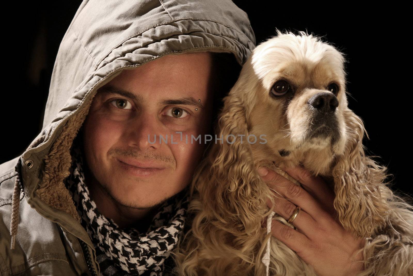 beauty fashion male and american cocker over a black background