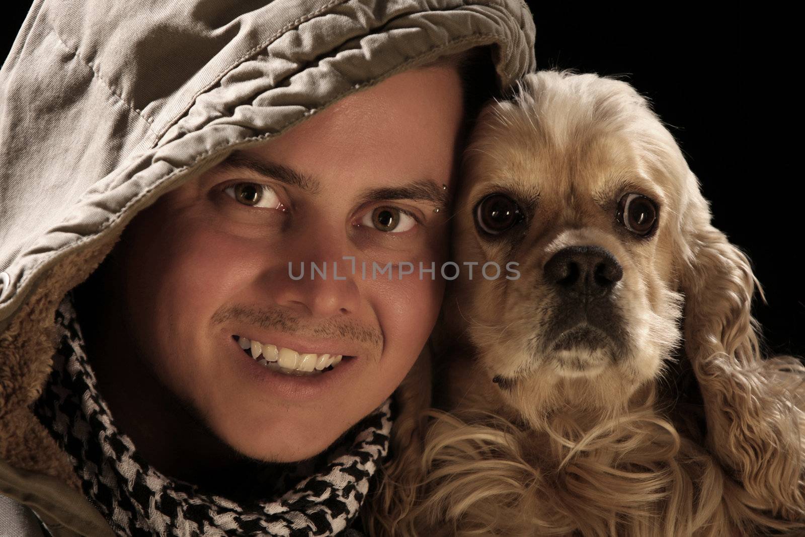 beauty fashion male and american cocker over a black background