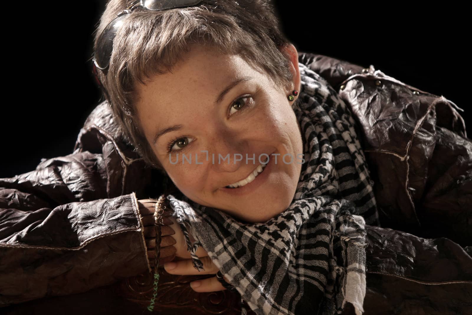 beauty woman in leather jacket over a black background