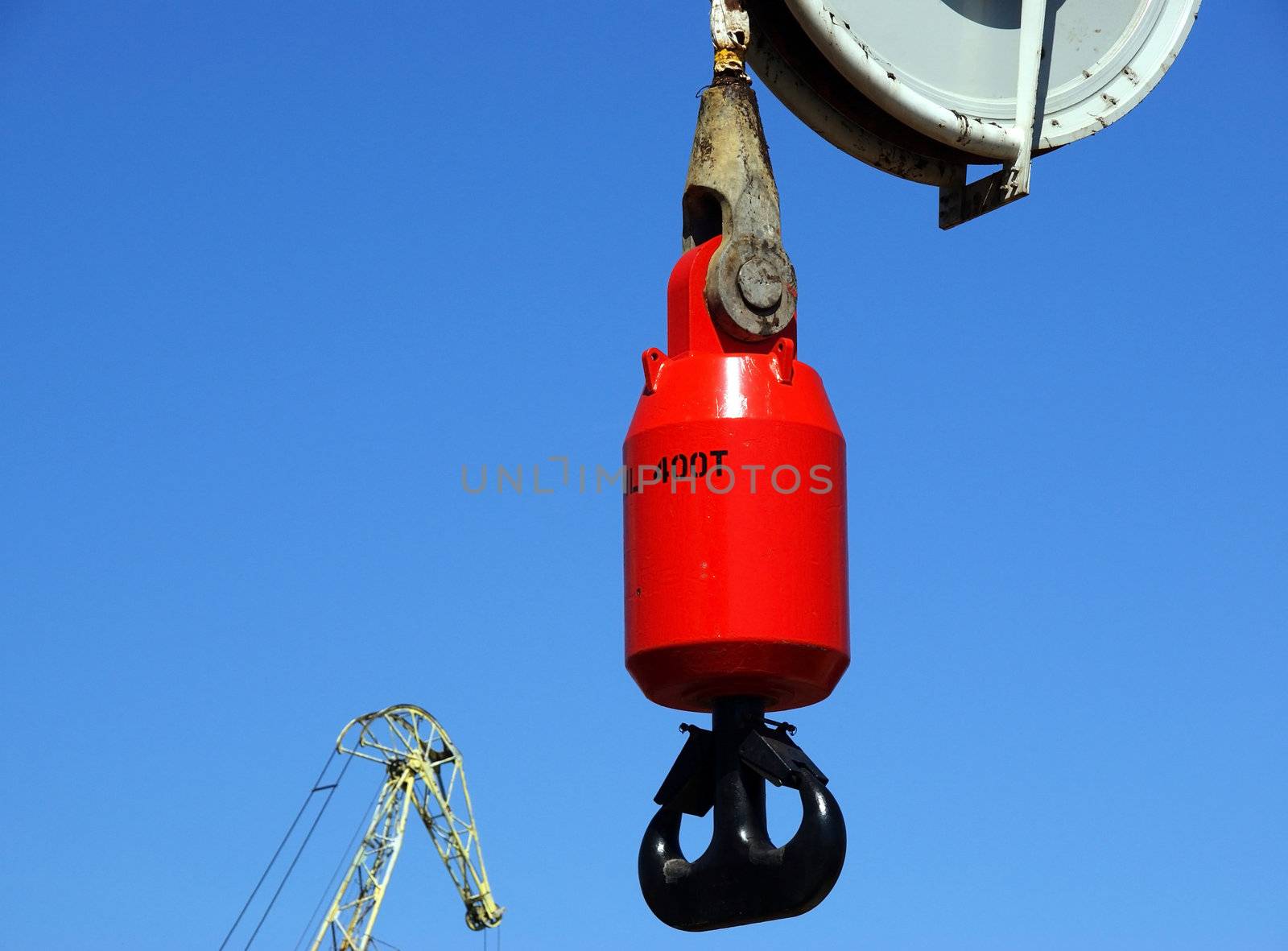 Hook of the powerful ship crane on a background of the blue sky