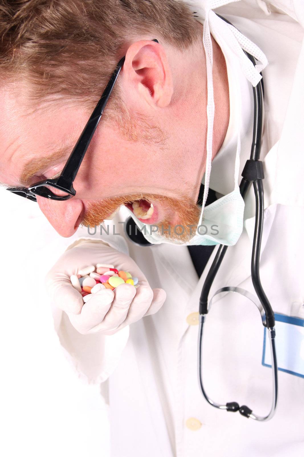 doctor taking hand full of tablets on white background