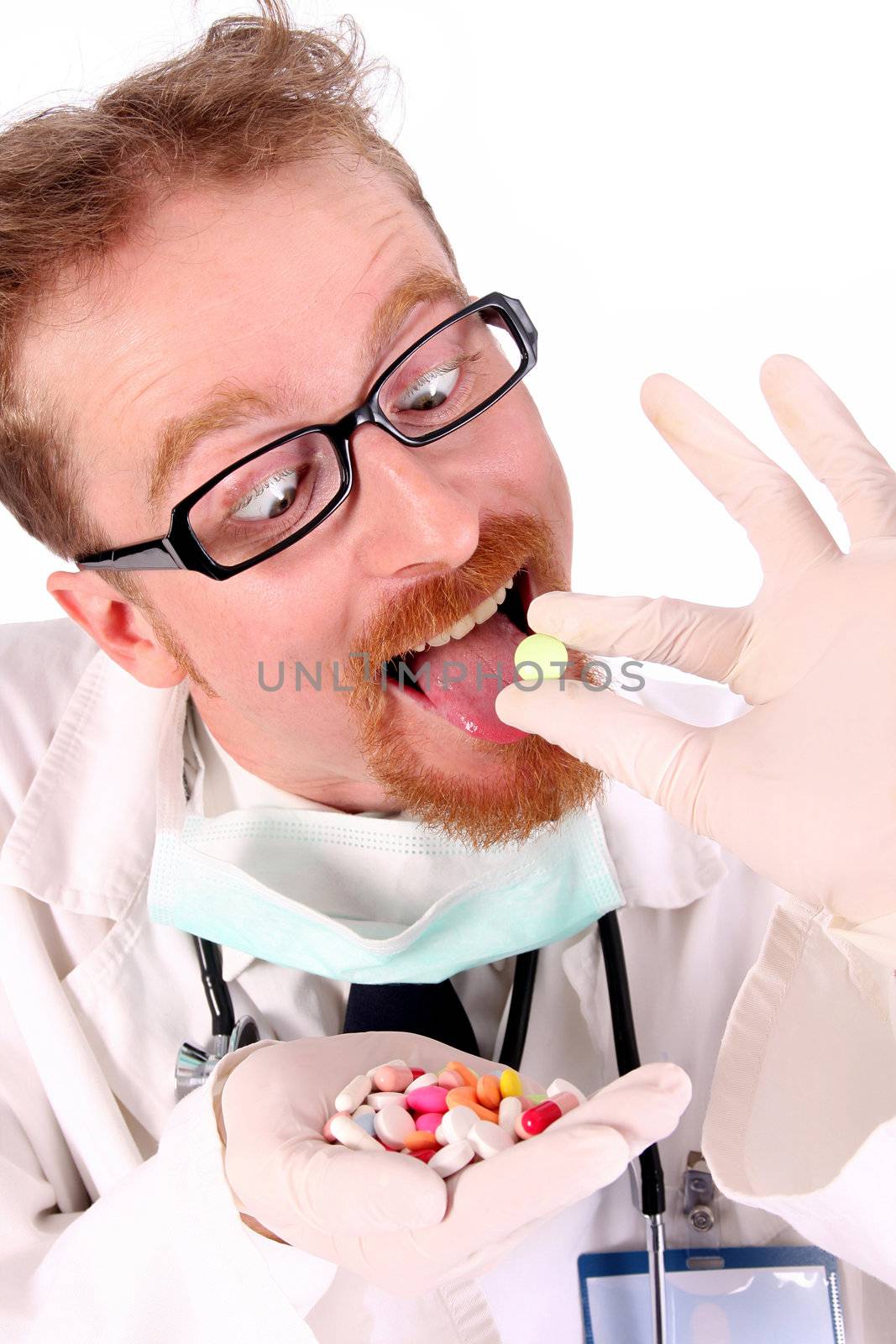 doctor taking hand full of tablets on white background