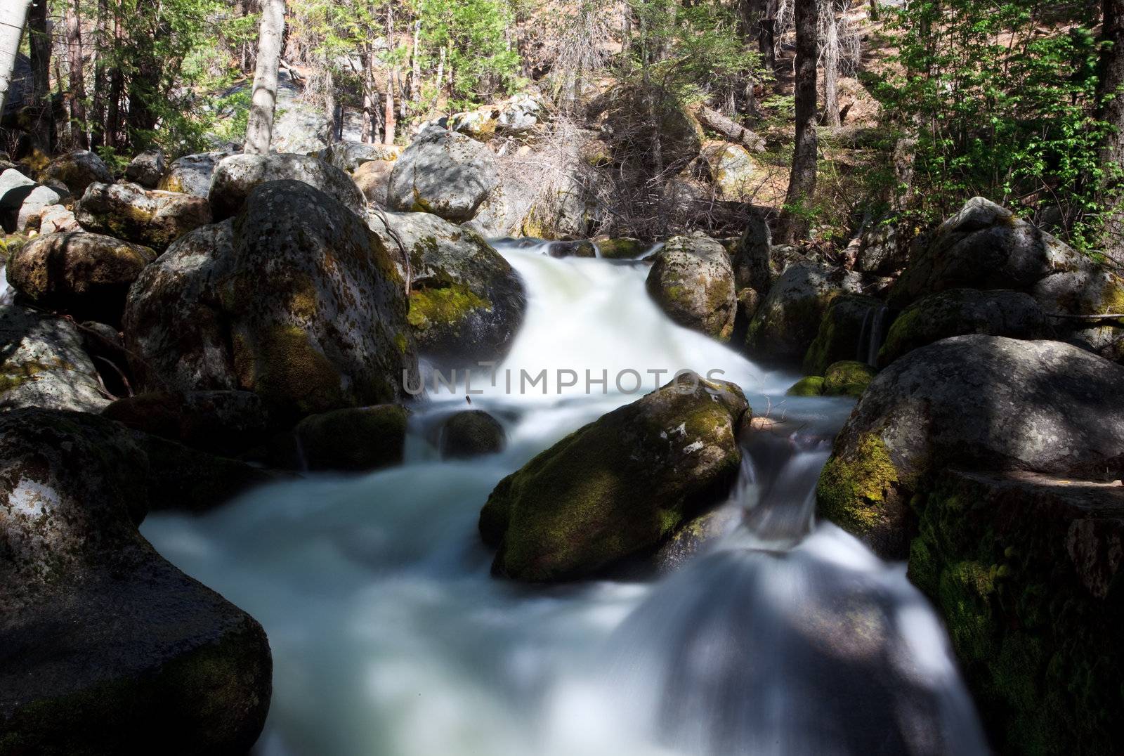 Peaceful river flowing over rocks by steheap