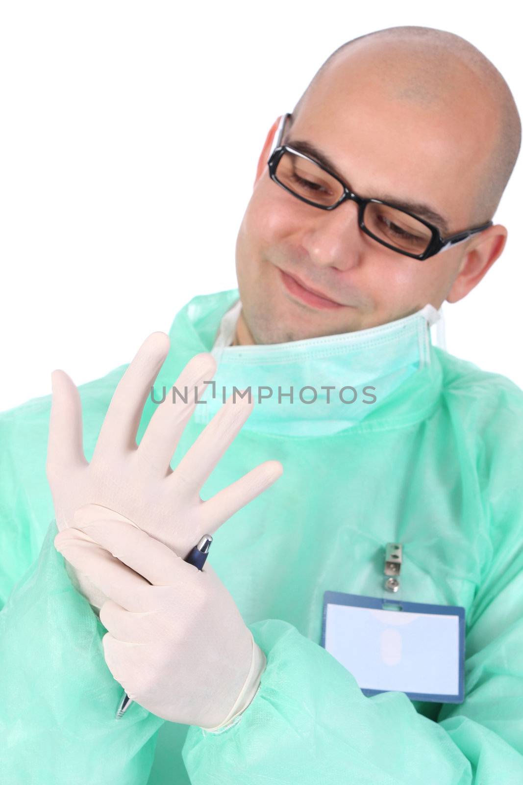 surgeon putting medical gloves on by vladacanon