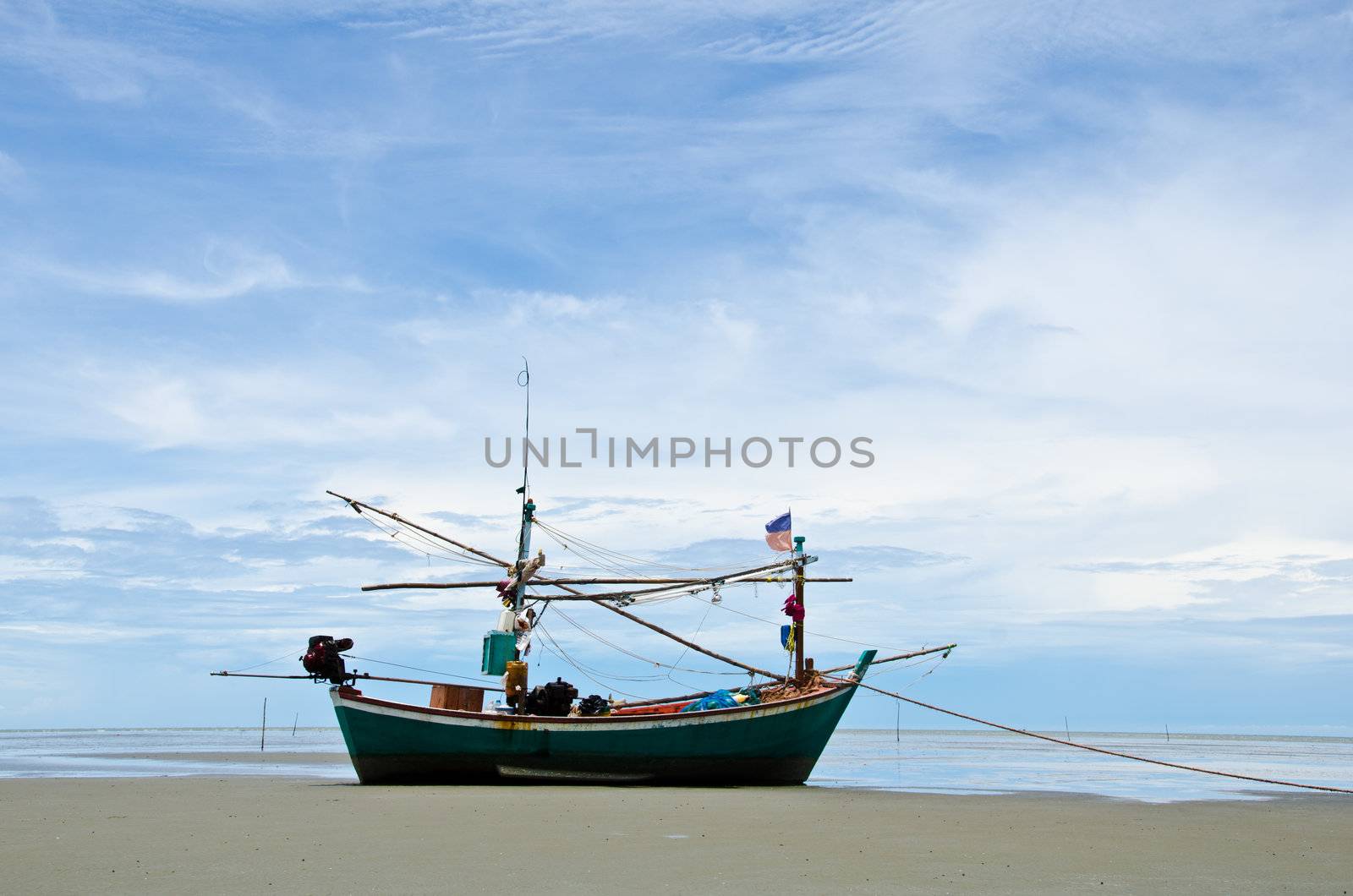 Coastal fishing boats anchor on the beach, Hua Hin, Thailand.