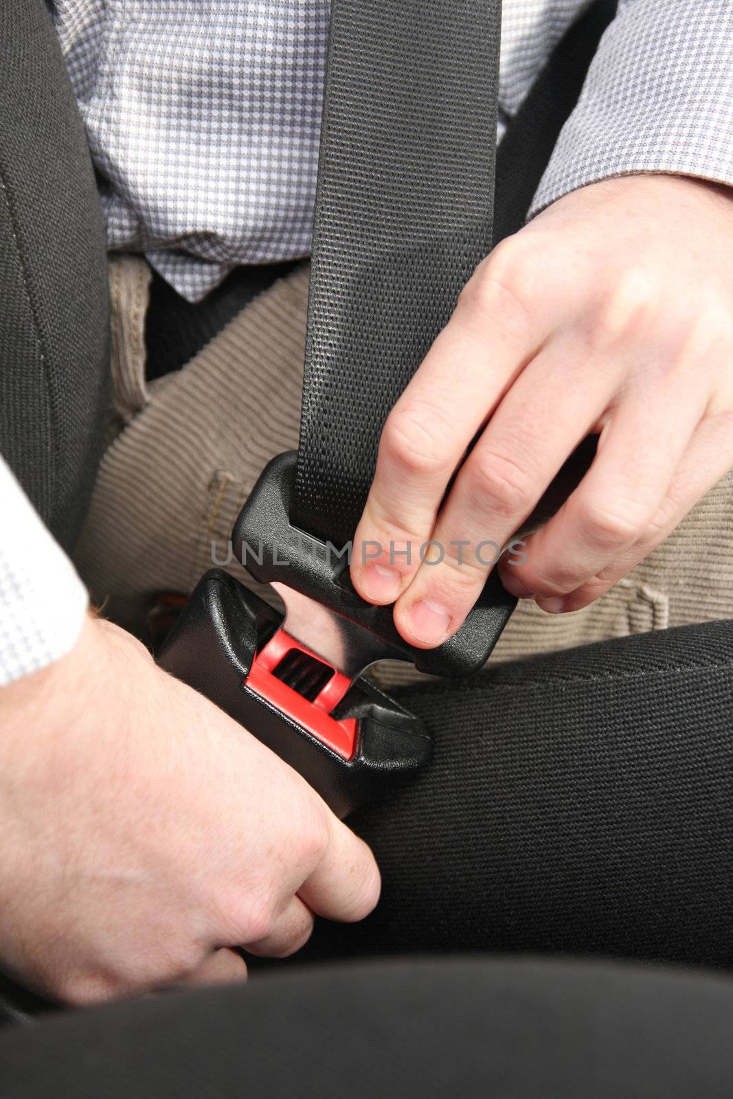 details of hands putting on safety belt