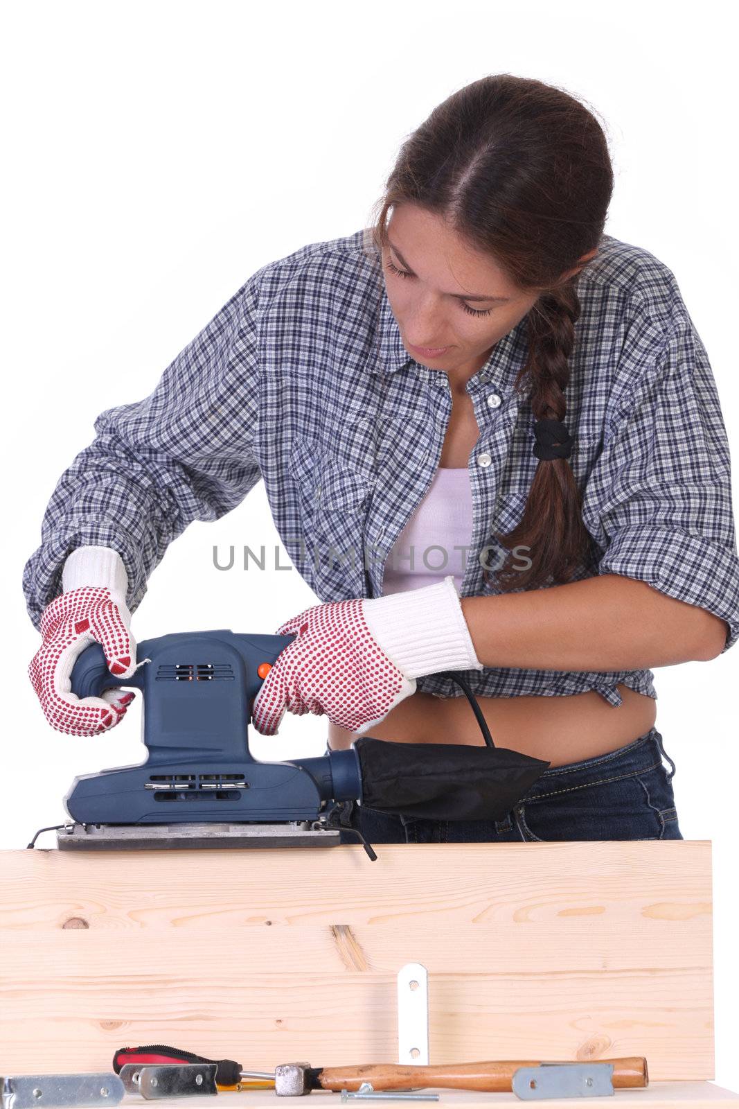 woman carpenter at work, sander by vladacanon