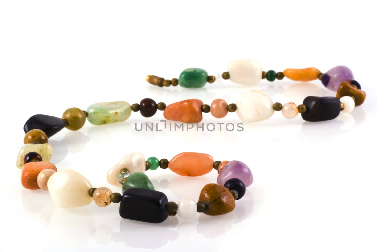 Necklace made of colorful natural stones isolated on white.