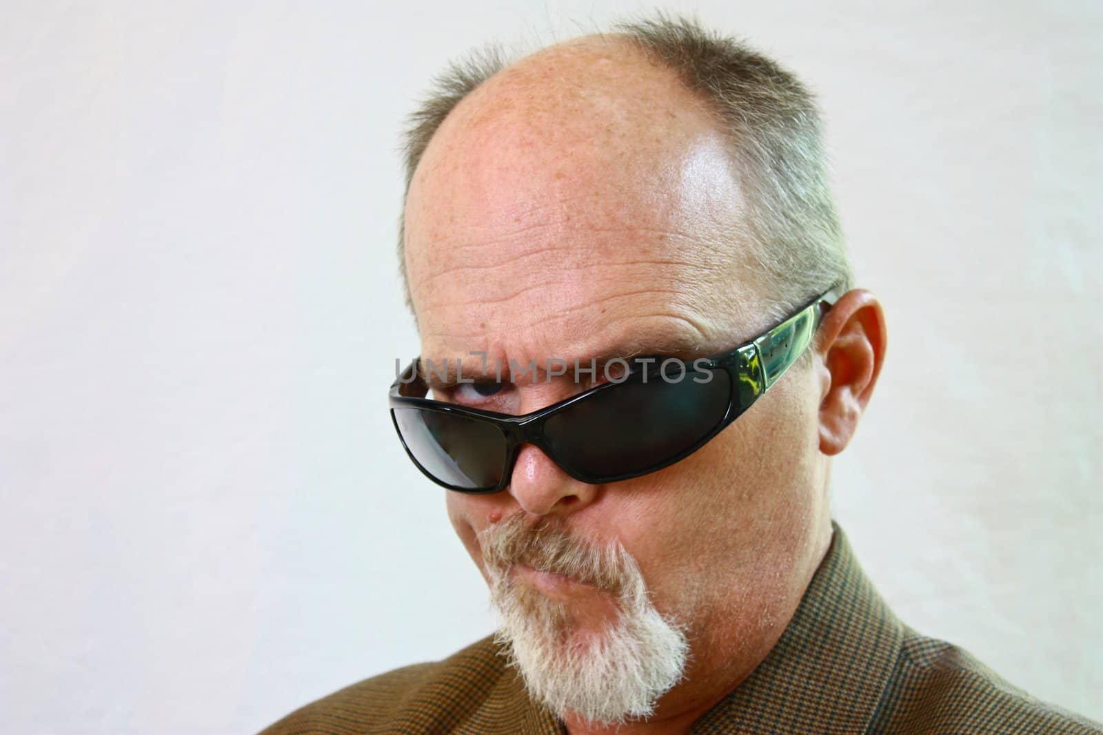Man with sunglasses and smirk on his face