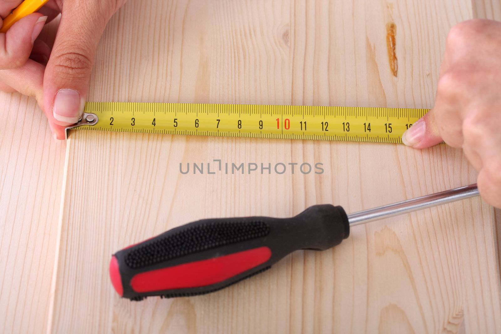 closeup shot of wooden plank and measuring tape 