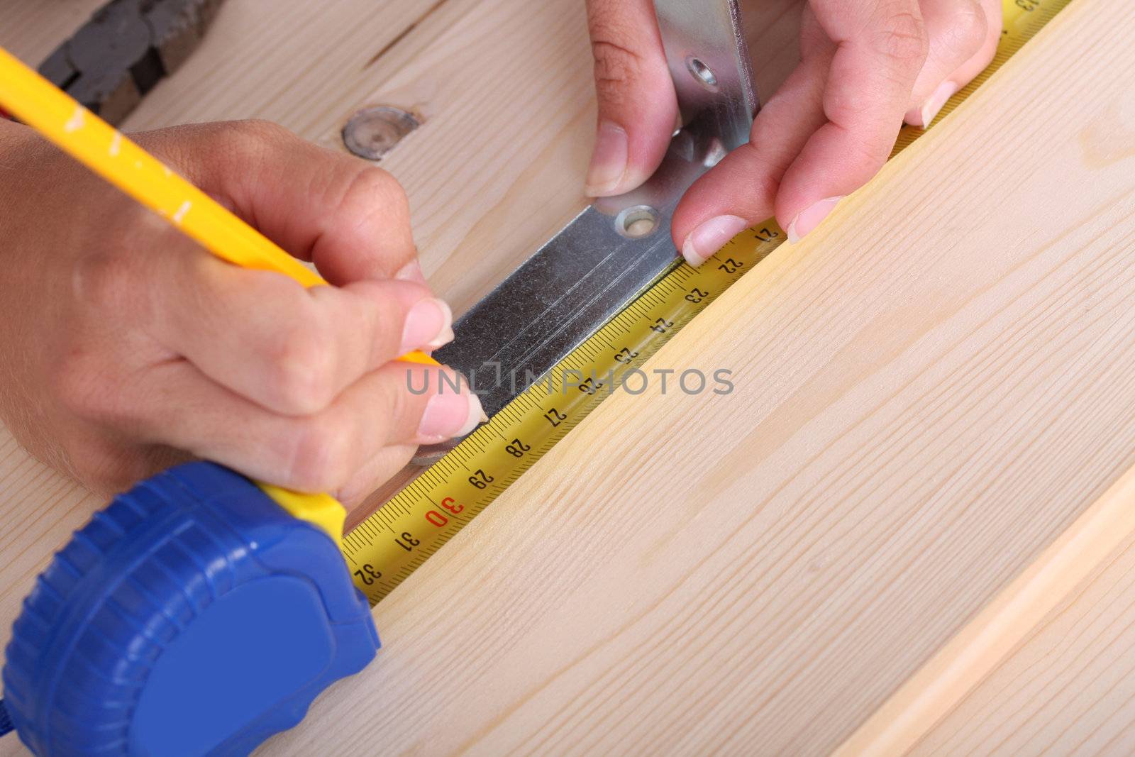 closeup shot of wooden plank and measuring tape 