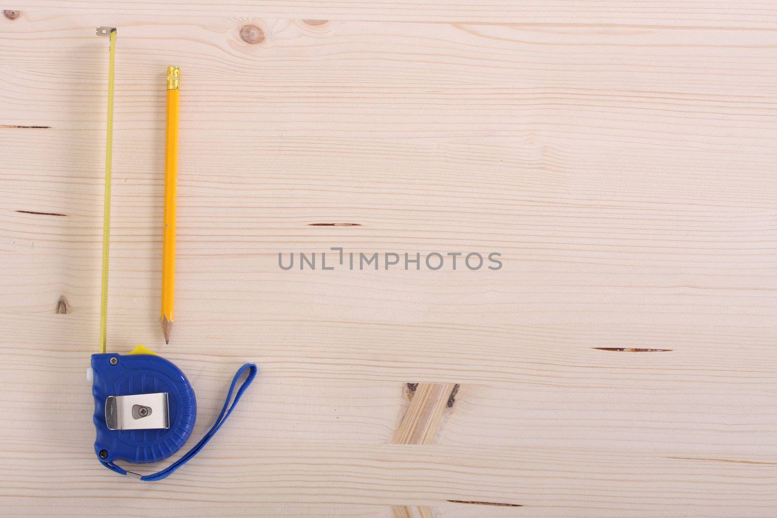 closeup shot of wooden plank and measuring tape 