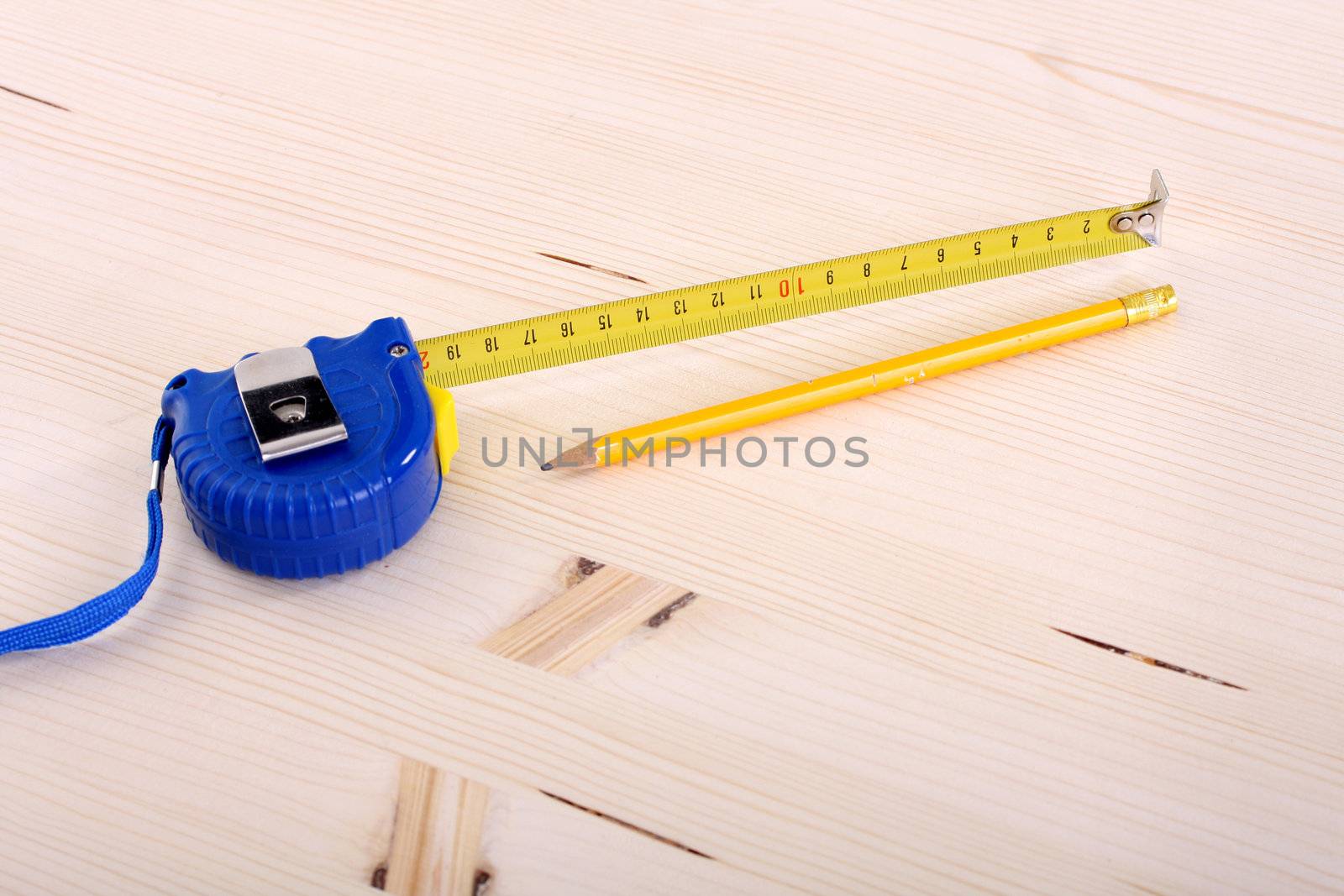 closeup shot of wooden plank and measuring tape 