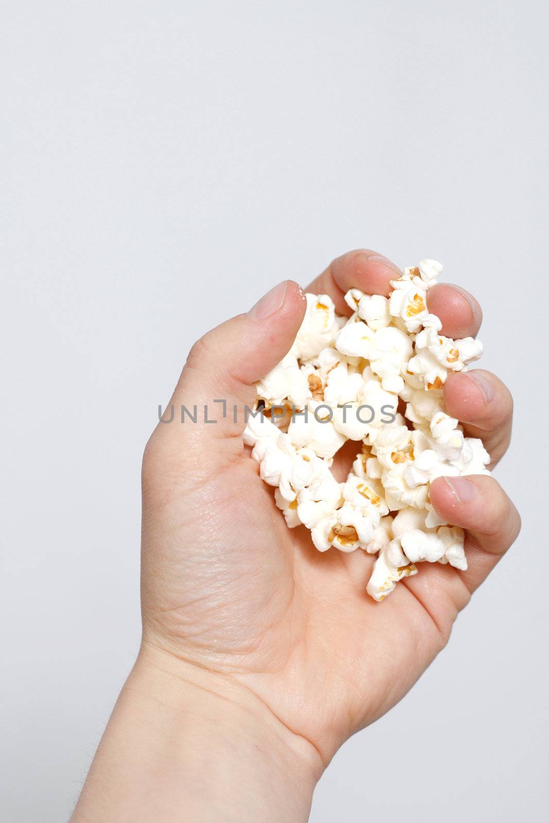 Hand holding popcorn by leeser