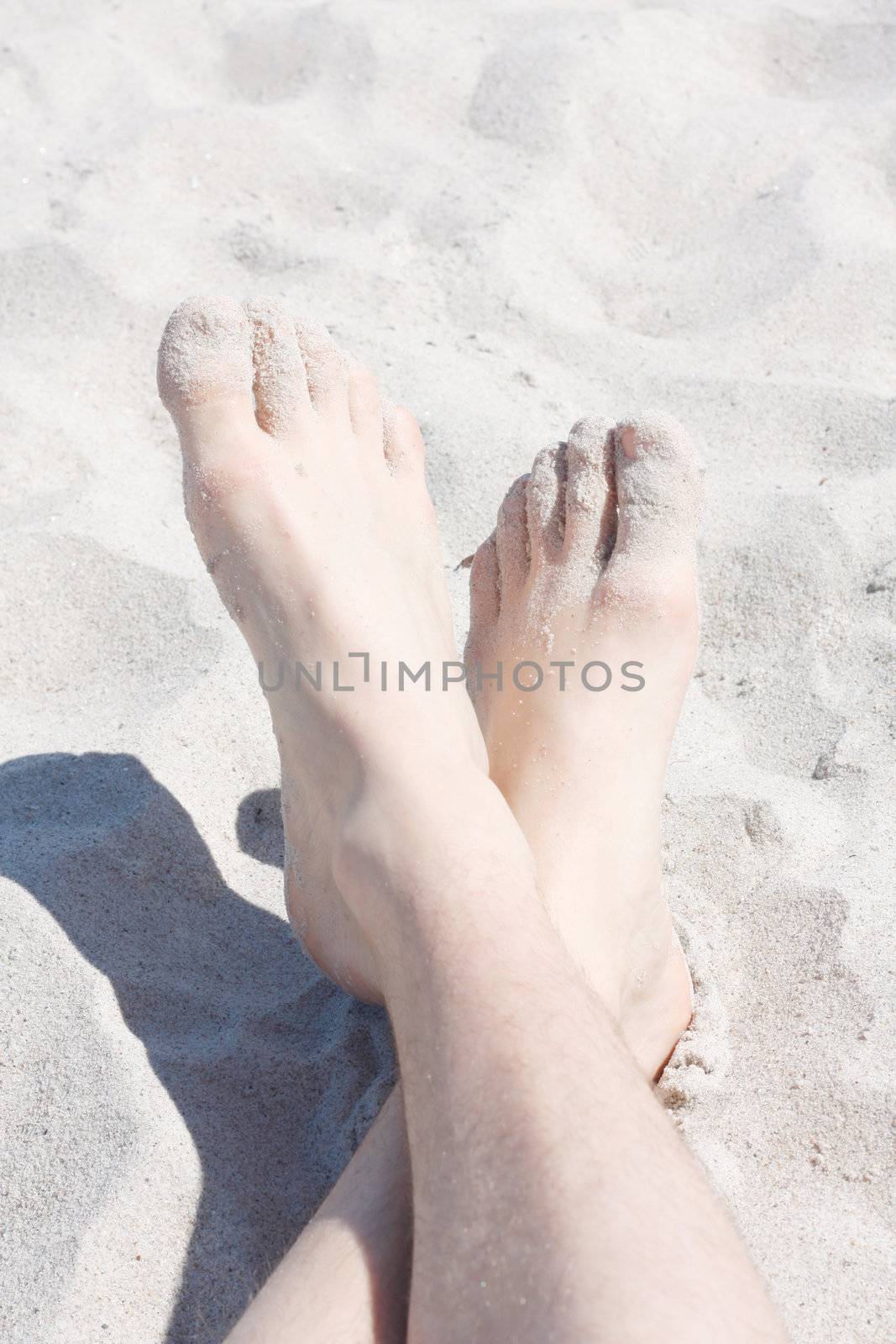 Feet on beach by leeser