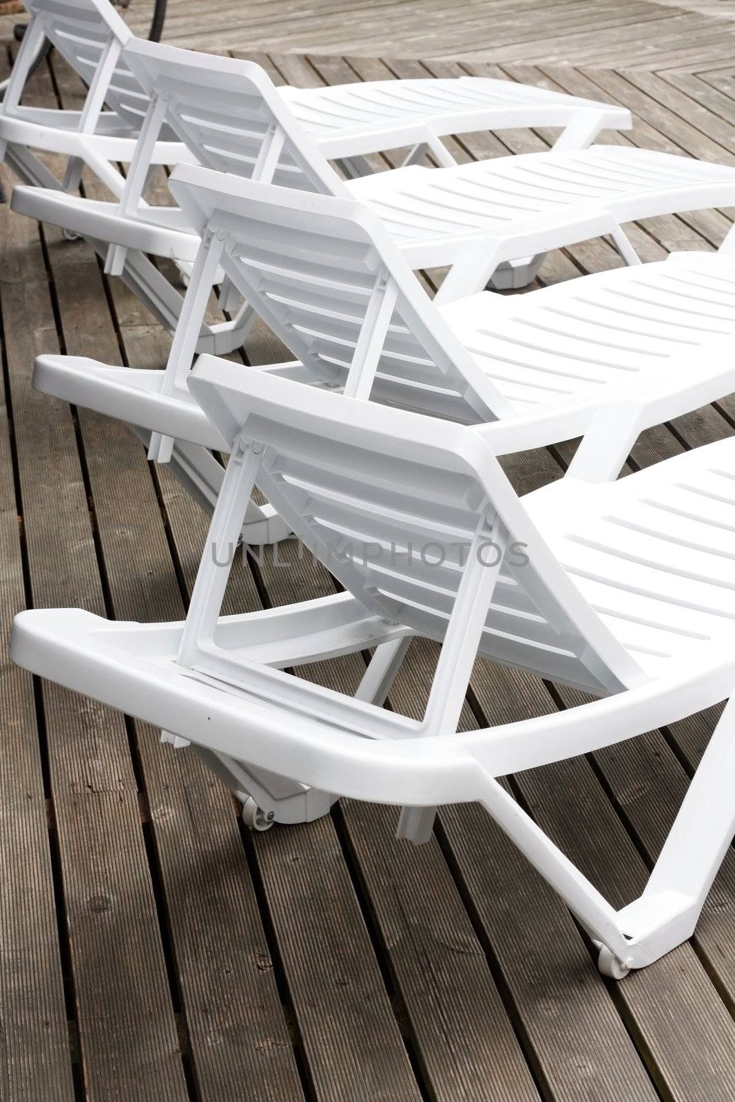 Plastic chairs by the pool