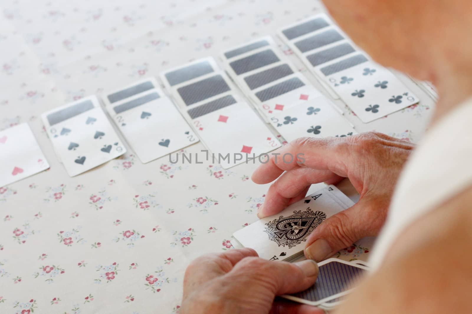 Senior playing solitaire