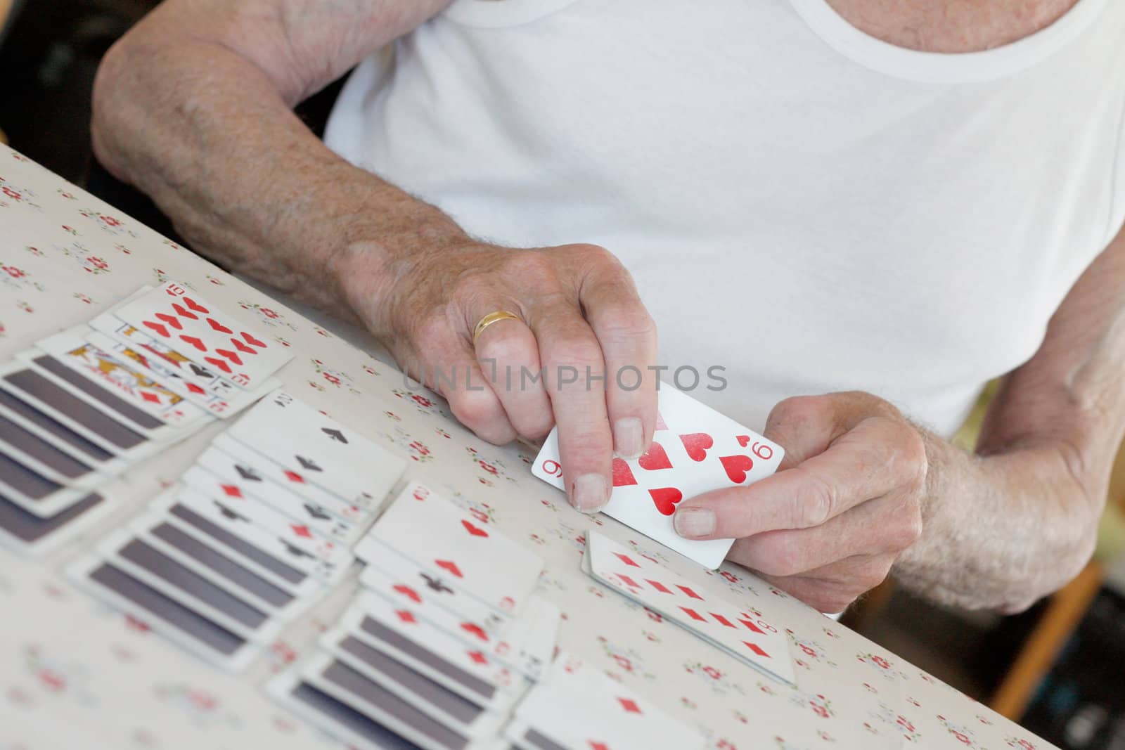 Senior playing solitaire