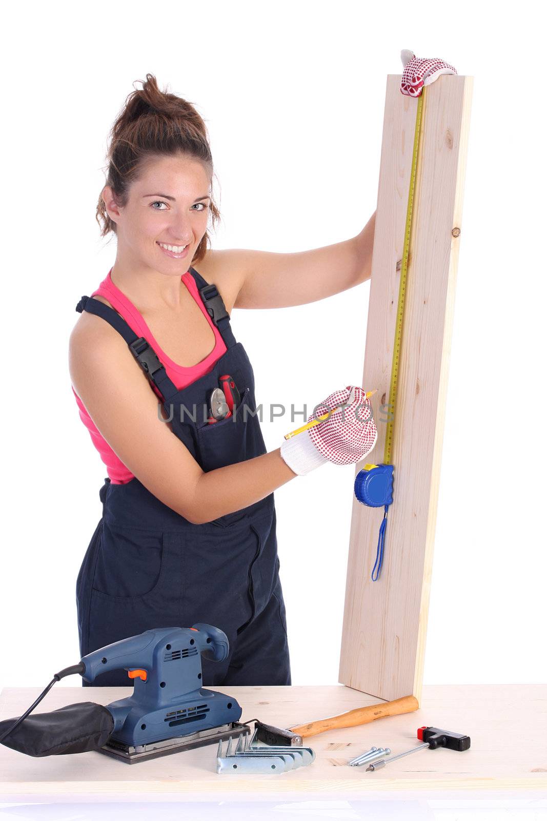 woman carpenter with wooden plank and measuring tape