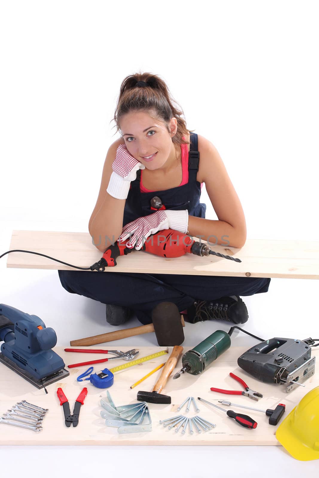 woman carpenter with work tools on wooden plank