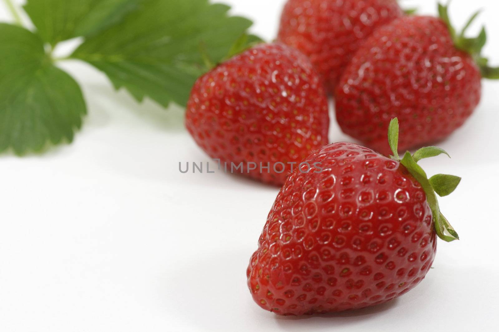 Close-up of fresh strawberries over white background