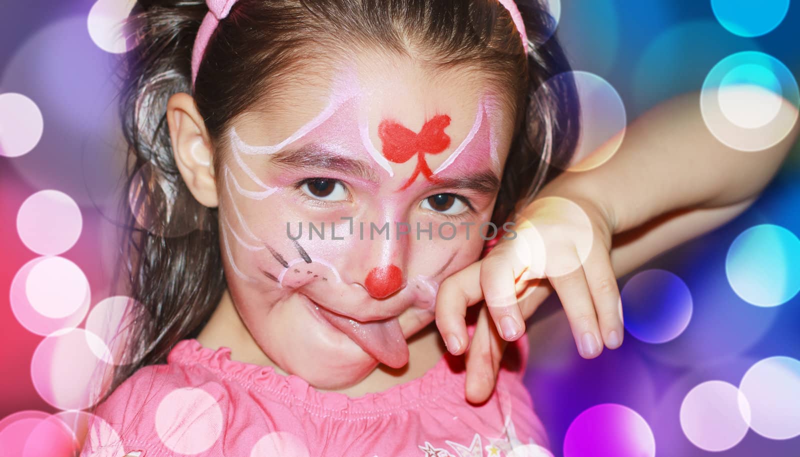 A happy young girl with face-paint on after a carnival