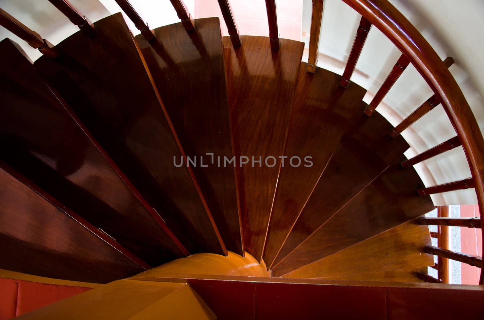 The curved wooden staircase down to the ground floor. by chatchai