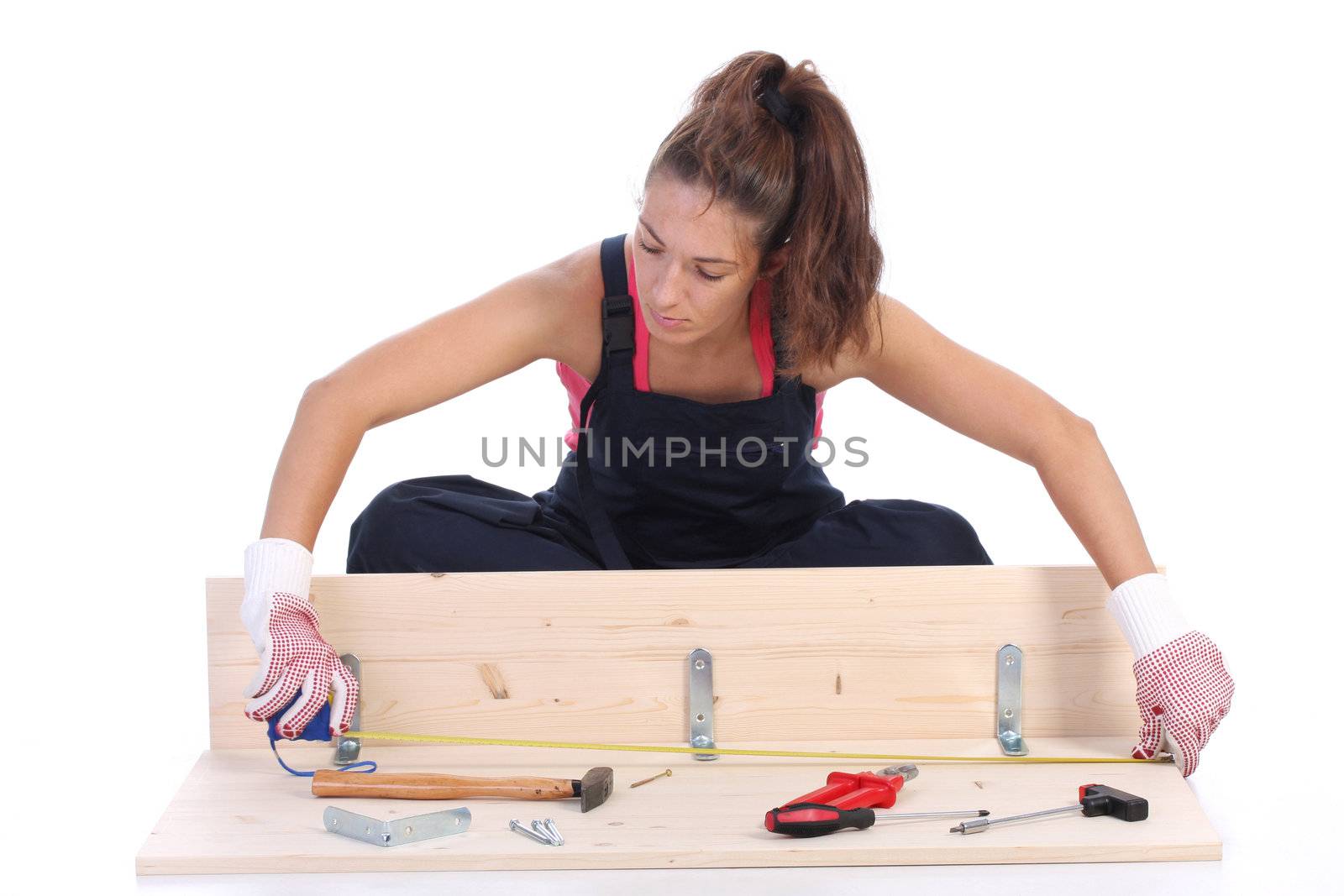 woman carpenter at work on white background 