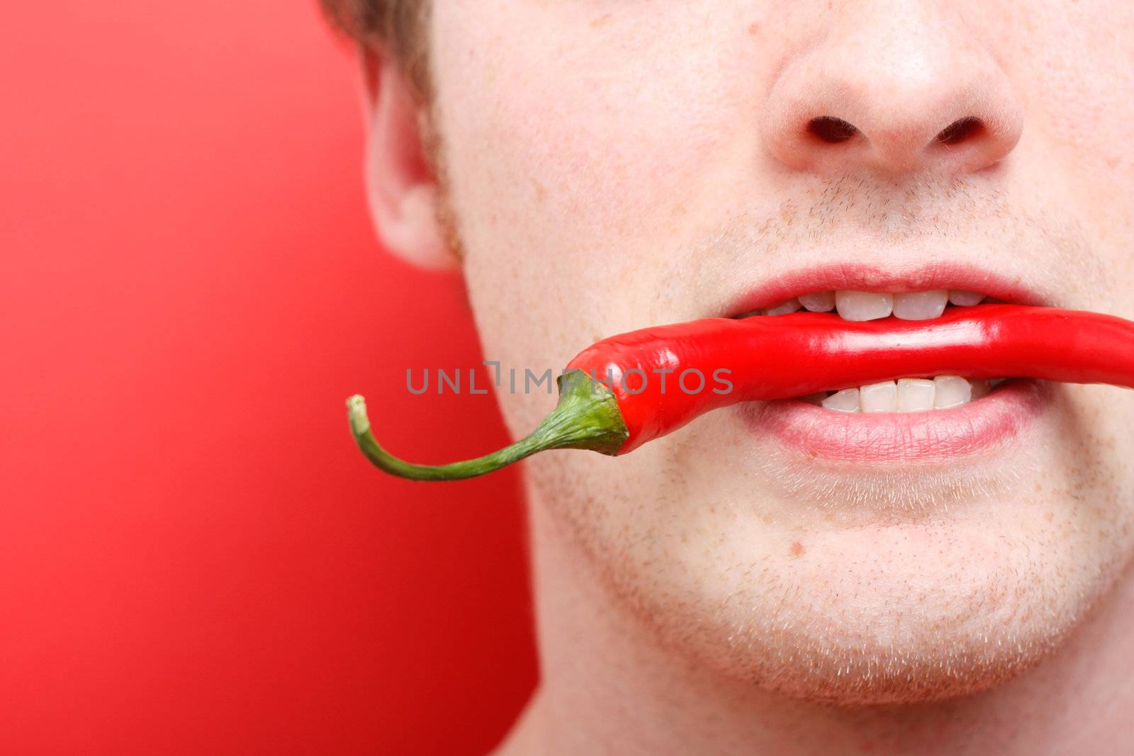 A man eating chili pepper