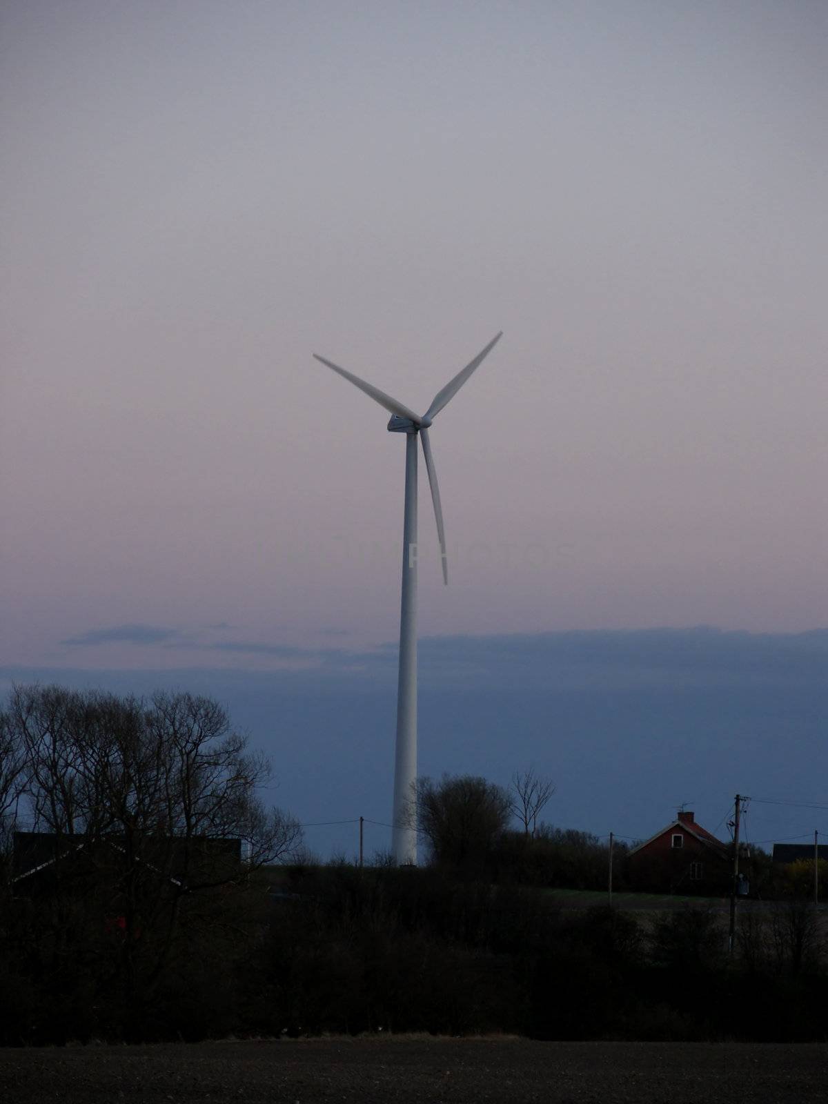 portrait of wind turbine in blue sky