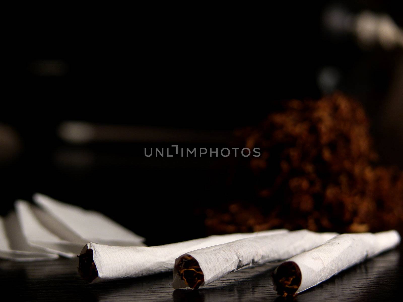 Portrait of handrolled joints on black