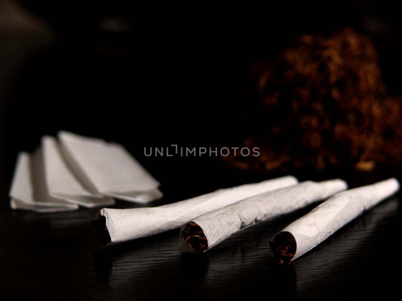 Portrait of handrolled joints on black