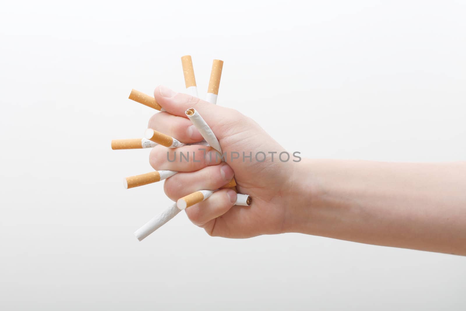 A hand crushing cigarettes