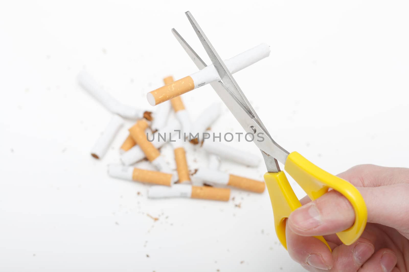 A hand cutting cigarettes