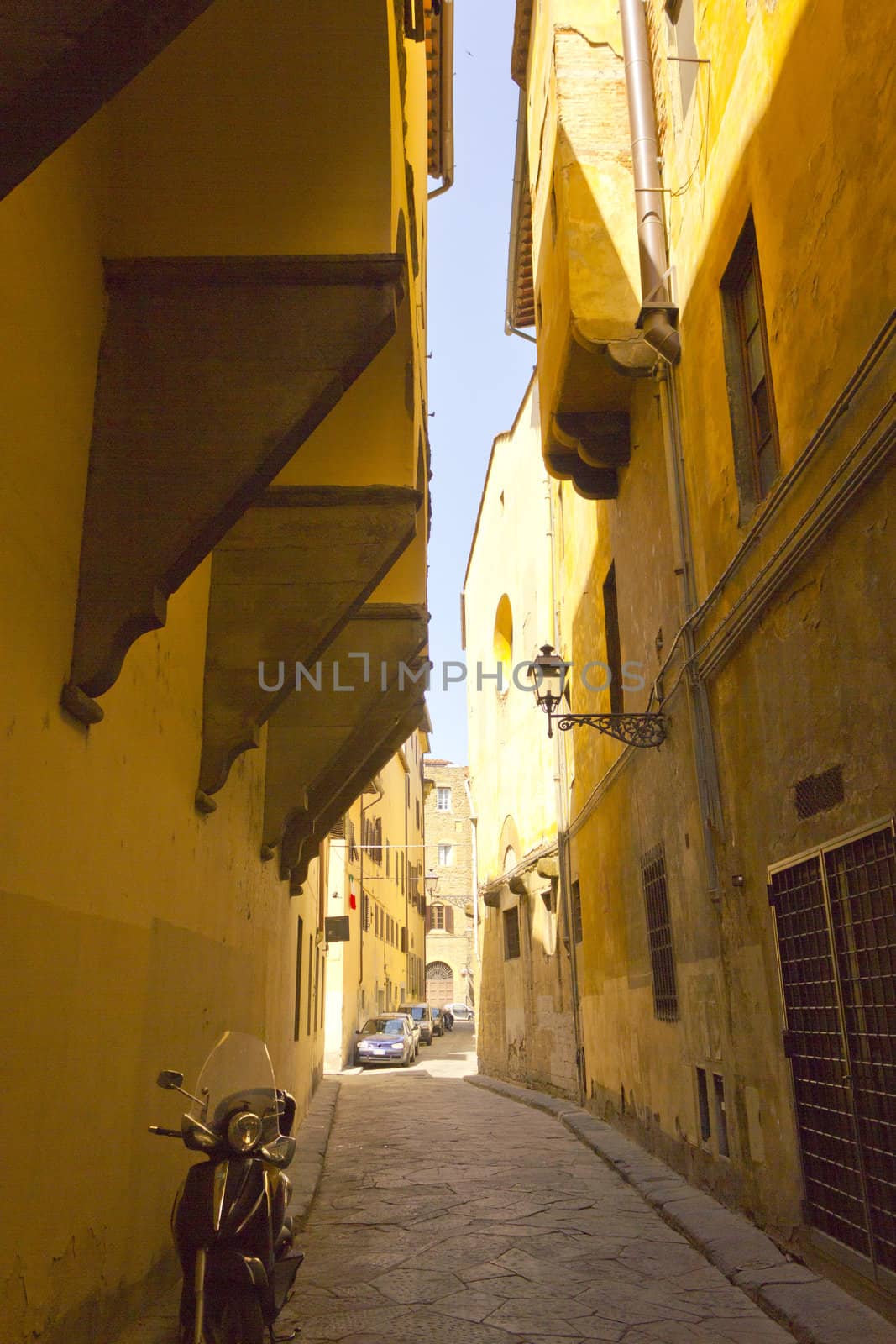 Narrow alley with old buildings in Florence Italy.