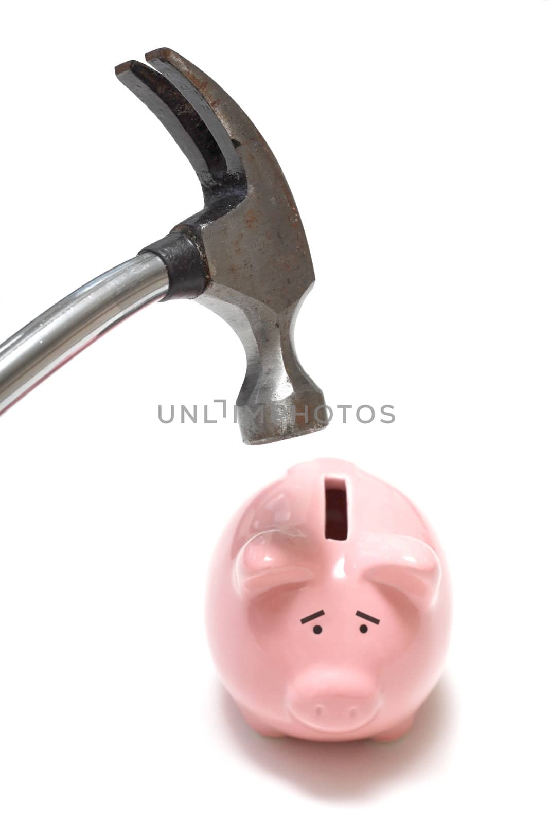 A hammer destroying a piggy bank