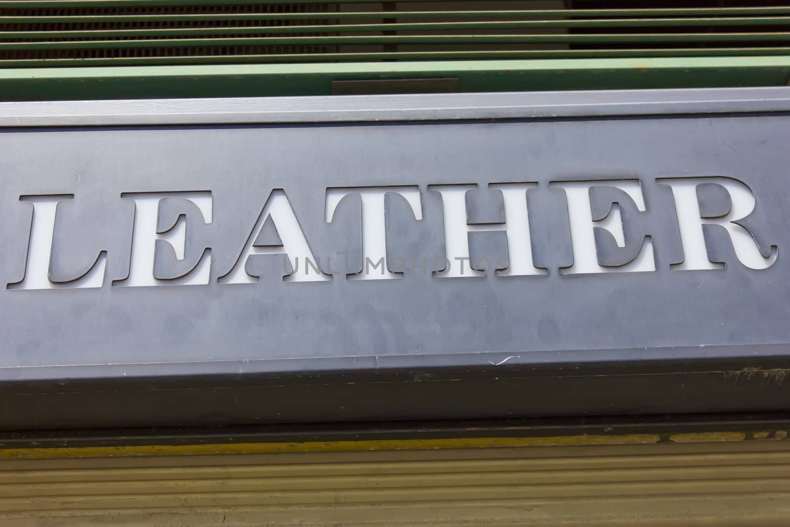 Image of leather sign in front of a leather goods shop.