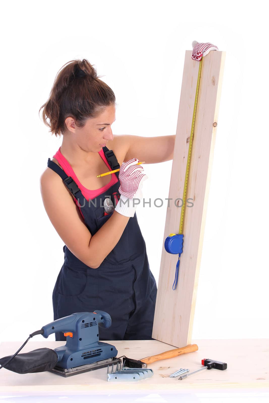 woman carpenter with wooden plank and measuring tape