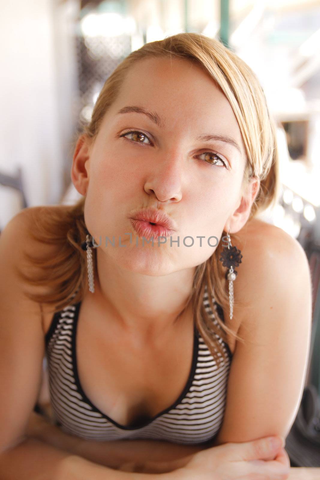 Beautiful young lady sending a kiss to the viewers.