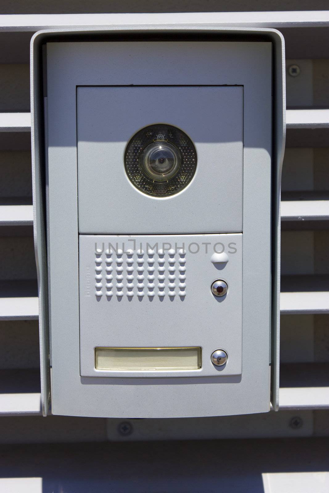 New outdoor intercom with camera and blank nameplate.