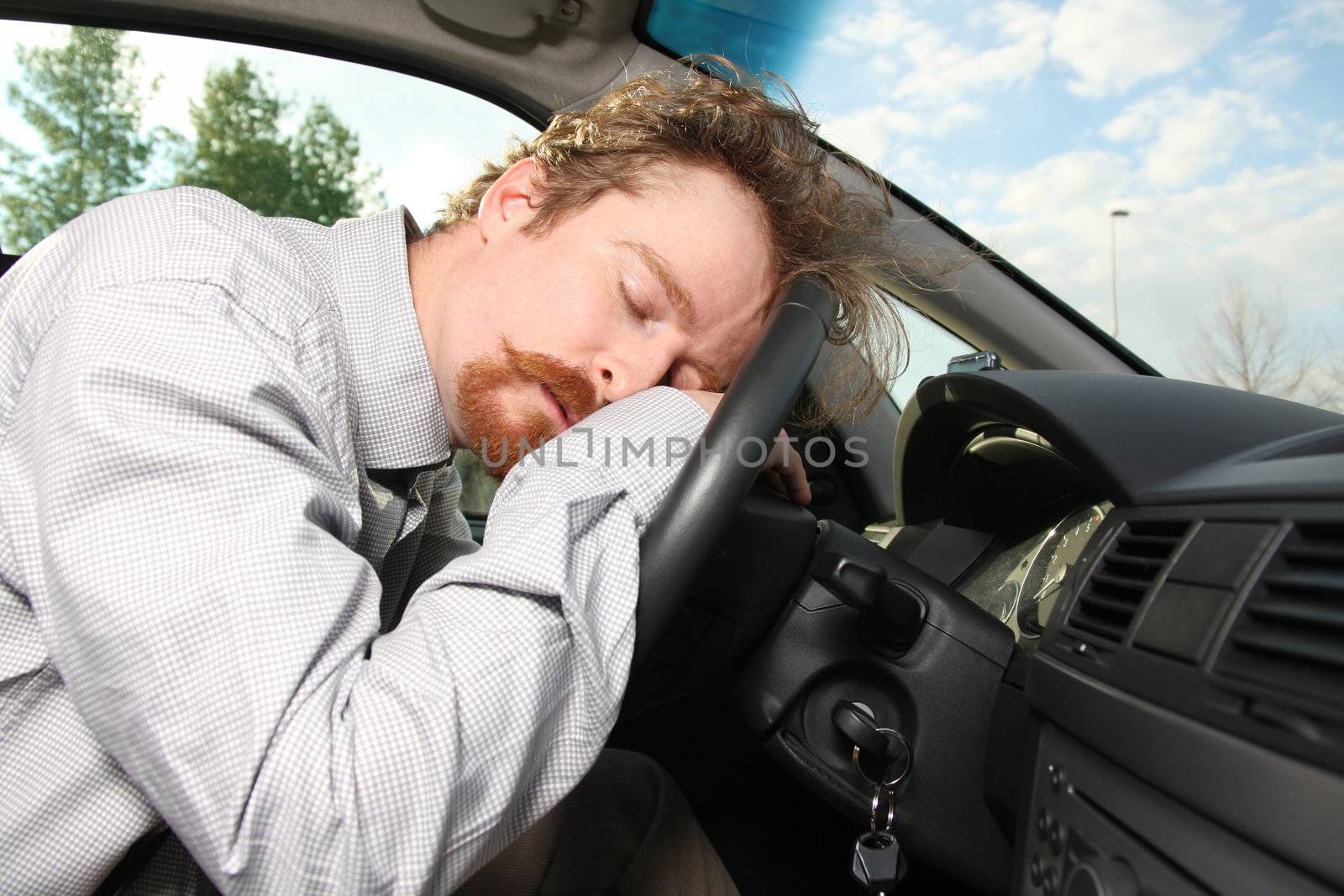 tired driver sleeps in a car